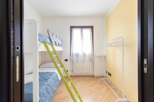 a room with a bunk bed and a ladder at Home Sweet Home in Albano SantʼAlessandro +8 photos