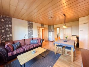 a living room with a couch and a table at Landhaus Landgelück in Hellenthal
