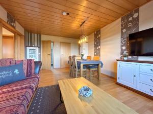 a living room with a couch and a table at Landhaus Landgelück in Hellenthal