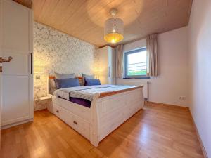 a bedroom with a large wooden bed in a room at Landhaus Landgelück in Hellenthal