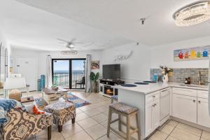 a kitchen and living room with a view of the ocean at "Summer Winds" at Sunglow Resorts with Spectacular Ocean Views in Daytona Beach Shores