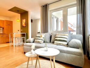 a living room with a couch and a table at Modernes Apartment mit Balkon in Neu Ulm