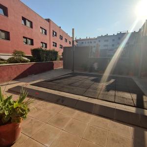 a person standing on a patio with a hose at VILLAS COSETTE Apartamento CAMILLE in Sant Feliu de Guixols