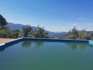 a swimming pool with a view of the mountains at Paraje del Almendral- Casa Grande in Lanjarón