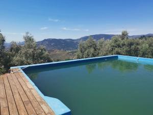 a swimming pool with a view of the mountains at Paraje del Almendral- Casa Grande in Lanjarón
