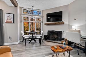 a living room with a fireplace and a tv at Laurelwood 44 with Wintergreen Advantage in Wintergreen