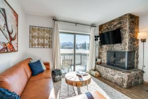 a living room with a couch and a fireplace at Condo with Balcony and Views - Steps to Ski Shuttle! in Fraser
