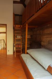 two bunk beds in a room with a ladder at Cozy Family Home in Amazing Mountain with piano in Candemil
