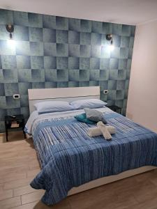 a bed with two stuffed animals on top of it at La Petite Maison in Naples