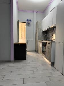 a kitchen with white cabinets and a tile floor at Destination In Rome in Rome