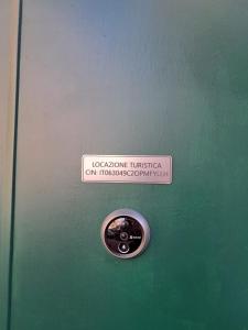 a metal door with a sign that reads locomotion tusken andbestosoperation at La Petite Maison in Naples