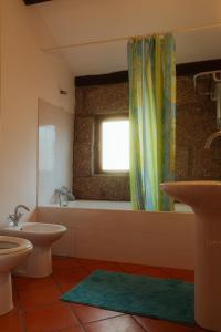 a bathroom with a tub and a toilet and a window at Cozy Family Home in Amazing Mountain with piano in Candemil +56 photos