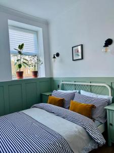 a bedroom with two beds and a window at Seashell Apartment - Central location in Folkestone