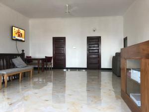 a living room with two doors and a table at VUGA Hostel in Zanzibar City