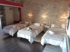 A bed or beds in a room at Cal Vibo