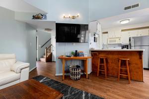 a kitchen and living room with a bar and a couch at Laurelwood 73 with Wintergreen Advantage in Wintergreen