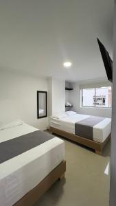 Postel nebo postele na pokoji v ubytování Hotel Medellín 66