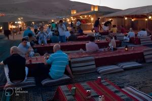 a group of people sitting around tables in the desert at Al Dora Residence Suites Hurghada in Hurghada +138 photos