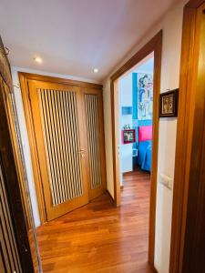 a hallway with a wooden door and a bedroom at Cubiculla Monte Mario in Rome