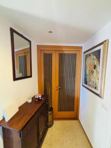 a room with a wooden desk and a door at Cubiculla Monte Mario in Rome