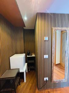 a room with a wall with a mirror and a table at Cubiculla Monte Mario in Rome