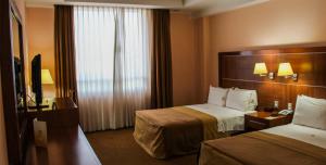 Postel nebo postele na pokoji v ubytování Hotel Soleil Celaya