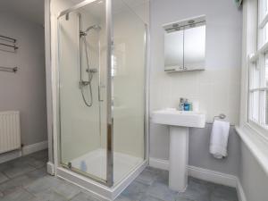 a bathroom with a shower and a sink at Trenouth Cottage in Padstow +29 photos