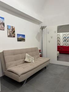 a living room with a brown couch in a room at Tellmewhy Puglia in Corato