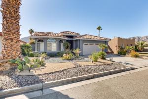 a house with a palm tree in front of it at Heated Pool at 3 BR Home 5 Mi to Coachella! in La Quinta