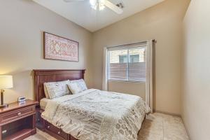 a bedroom with a bed and a window at Heated Pool at 3 BR Home 5 Mi to Coachella! in La Quinta +17 photos