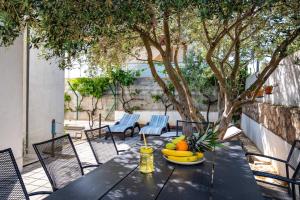 a table with a bowl of fruit on a patio at MY DALMATIA - Sea view apartment Dajana with private pool in Maslenica