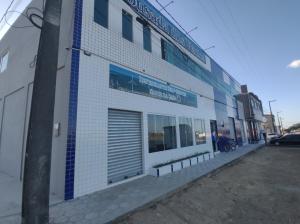 a building with a garage door on the side of it at Pousada dos Ventos in Paranatama