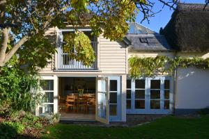 an extension to a house with sliding glass doors at Pear Tree Cottage in Shaldon