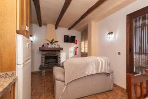 a living room with a couch and a fireplace at Muley Hacén in Capileira