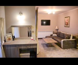 a living room with a couch and a table at Хотел ЛОНДОН in Svilengrad