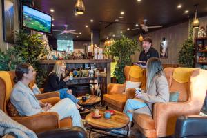a group of people sitting in a bar at The KG Residence in Kiama