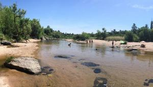a group of people playing in the water on a beach at Cabaña Tala Huasi in Villa Icho Cruz +3 photos