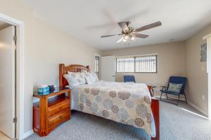a bedroom with a bed and a ceiling fan at Casa Flamingo in Cocoa Beach +18 photos