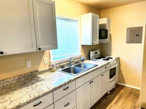 a kitchen with a sink and a stove at Westerner Motel in Chadron