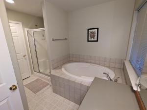 a bathroom with a shower and a white tub at Aazure Like It - Eagle Crest Resort, Fun & Relaxation Headquarters in Redmond +19 photos