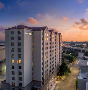 a view of a white building at sunset at Sonesta ES Suites San Antonio Downtown Alamo Plaza - Newly Renovated in San Antonio