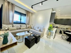 a living room with a couch and a table at Central Large Suite with Balcony & Beach view in Tangier