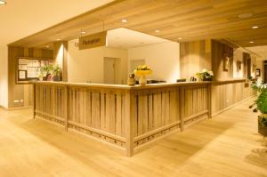 a lobby with a reception counter in a building at BSW Hotel Isarwinkel in Bad Tölz