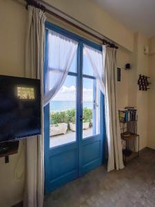 Televízia a/alebo spoločenská miestnosť v ubytovaní Kyparissis Beach Houses