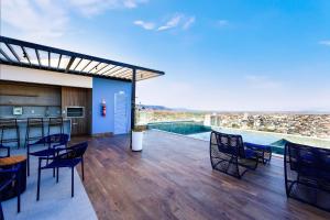 a deck with chairs and a bar with a view at Estúdios modernos no City House by WeHousy in Barreiras