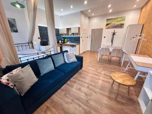 a living room with a blue couch and a table at Gliwicka5 przy Rynku in Tarnowskie Góry