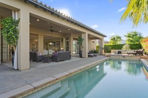 a house with a swimming pool in front of a house at Luxury Griffin Estate 4900sf Compound Pure luxury WALK TO COACHELLA AND STAGECOACH in La Quinta