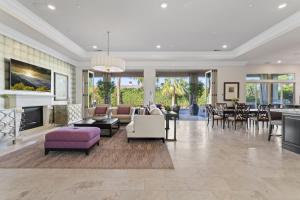 a living room filled with furniture and a fireplace at Luxury Griffin Estate 4900sf Compound Pure luxury WALK TO COACHELLA AND STAGECOACH in La Quinta