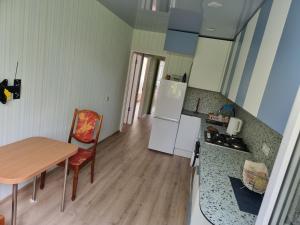 a kitchen with a table and a small kitchen with a table and a tablektop at Kaunas 174 in Kaunas