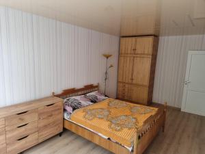 a bedroom with a bed and a dresser at Kaunas 174 in Kaunas